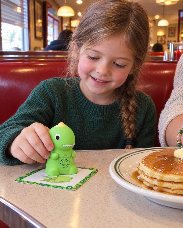 A girl plays with Echo at a diner table